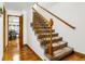 Traditional staircase featuring carpeted steps, wooden rails, and an open doorway to the dining room at 12414 Clayton Way, Thornton, CO 80241