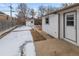 View of backyard with a walkway, shed, and freshly painted white siding on home at 1195 Ammons St, Lakewood, CO 80214