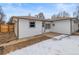 Back exterior of home showing siding and snow in the backyard at 1195 Ammons St, Lakewood, CO 80214