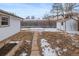 Backyard featuring a shed, wooden fence, and potential garden bed, all nestled in a tranquil setting at 1195 Ammons St, Lakewood, CO 80214