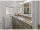 Well-lit bathroom features a granite countertop, cabinets, and mirror with integrated lighting at 1195 Ammons St, Lakewood, CO 80214