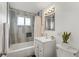 Bathroom featuring tiled shower-tub combination and modern vanity with updated fixtures at 1195 Ammons St, Lakewood, CO 80214