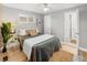 Cozy bedroom with light gray walls and a ceiling fan, adjacent to bathroom at 1195 Ammons St, Lakewood, CO 80214