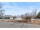 A view of the exterior of a well-kept residence, complemented by mature trees at 1195 Ammons St, Lakewood, CO 80214