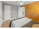 Spacious main bedroom with wood accent wall, ceiling fan, and access to other rooms at 1195 Ammons St, Lakewood, CO 80214