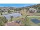 Expansive aerial view of a picturesque community featuring a pond, playground, and lush greenery at 730 Summerwood Dr, Golden, CO 80401