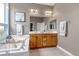 Bright bathroom featuring a soaking tub, tiled vanity and a double sink at 730 Summerwood Dr, Golden, CO 80401