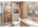 Bathroom with tile shower, wood accents, and modern fixtures at 730 Summerwood Dr, Golden, CO 80401