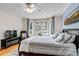 Bright bedroom features a large bay window, ceiling fan, and comfortable furnishings at 730 Summerwood Dr, Golden, CO 80401
