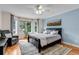 Light-filled bedroom with hardwood floors, accent rug and oversized scenic painting at 730 Summerwood Dr, Golden, CO 80401