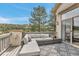 Cozy outdoor deck with comfortable seating area and views of pine trees and scenic mountains at 730 Summerwood Dr, Golden, CO 80401