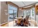 Dining area with a large window, hardwood floors, wood table and access to deck at 730 Summerwood Dr, Golden, CO 80401