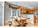 Sunlit dining room with wood floors, a dining table, and a bay window overlooking scenic views at 730 Summerwood Dr, Golden, CO 80401