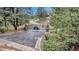 Gated entrance with stone pillars providing privacy and security to the property at 730 Summerwood Dr, Golden, CO 80401