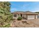 Charming home with stone accents, a three-car garage, and a welcoming front yard at 730 Summerwood Dr, Golden, CO 80401