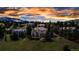 Beautiful home surrounded by lush trees and manicured landscaping under a stunning sky at 730 Summerwood Dr, Golden, CO 80401