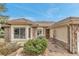 Charming single-story home featuring a stone and stucco exterior with a tile roof and landscaped front yard at 730 Summerwood Dr, Golden, CO 80401