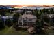 Gorgeous home with a balcony overlooking a manicured lawn surrounded by mature trees at 730 Summerwood Dr, Golden, CO 80401