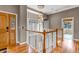 Bright hallway with wood floors and a decorative chandelier leading to various rooms in the house at 730 Summerwood Dr, Golden, CO 80401