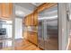 Kitchen featuring stainless steel refrigerator and oven, and wood cabinets at 730 Summerwood Dr, Golden, CO 80401