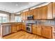 Kitchen with stainless steel appliances, tile backsplash, granite countertops and wood cabinets at 730 Summerwood Dr, Golden, CO 80401