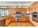 Well-equipped kitchen featuring wood cabinets, granite countertops, and stainless steel appliances at 730 Summerwood Dr, Golden, CO 80401