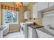 Convenient laundry room with a washer, dryer, utility sink, and ample cabinet space at 730 Summerwood Dr, Golden, CO 80401