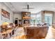 Spacious living room featuring a stone fireplace, hardwood floors, and large windows with views at 730 Summerwood Dr, Golden, CO 80401