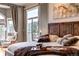 Relaxing bedroom with a wooden frame bed and tree top views from the large windows at 730 Summerwood Dr, Golden, CO 80401