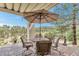 Inviting outdoor patio features a dining area with an umbrella and scenic views of the surrounding landscape at 730 Summerwood Dr, Golden, CO 80401