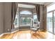 Sunlit sitting area with an inviting gray chair with a view of the surrounding forest at 730 Summerwood Dr, Golden, CO 80401