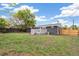 A backyard featuring a well-maintained lawn, a wooden fence, and a gray deck at 3540 E 91St Ave, Thornton, CO 80229