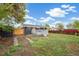 A cozy backyard featuring a well-maintained lawn, a wooden fence, and a gray deck at 3540 E 91St Ave, Thornton, CO 80229