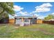 A cozy backyard featuring a well-maintained lawn, a wooden fence, and a gray deck at 3540 E 91St Ave, Thornton, CO 80229