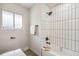 Modern bathroom featuring sleek white subway tile in the shower and a bright window at 3540 E 91St Ave, Thornton, CO 80229