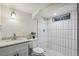 Basement bathroom features a new modern shower with white tile, new fixtures and an updated vanity at 3540 E 91St Ave, Thornton, CO 80229