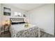 Bright bedroom featuring a large window, modern décor, and hardwood floors at 3540 E 91St Ave, Thornton, CO 80229