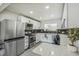 Modern kitchen boasts white cabinets, stainless appliances, black subway tile backsplash and a bar-style seating area at 3540 E 91St Ave, Thornton, CO 80229