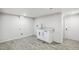 Charming laundry room with gray floors, white cabinet, stainless steel sink and white door at 3540 E 91St Ave, Thornton, CO 80229