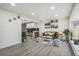 Open-concept living room flows seamlessly into a modern kitchen with stainless steel appliances and stylish countertops at 3540 E 91St Ave, Thornton, CO 80229
