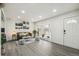 Bright living room with a large window, fresh paint, modern lighting and attractive gray-toned flooring at 3540 E 91St Ave, Thornton, CO 80229