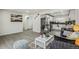 Open-concept living room flows seamlessly into a modern kitchen with stainless steel appliances and stylish countertops at 3540 E 91St Ave, Thornton, CO 80229