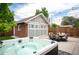 Private backyard with a hot tub, patio furniture, and a charming detached garage, perfect for entertaining at 1532 Meade St, Denver, CO 80204