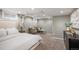 Basement bedroom with sitting area, white painted brick wall, and soft carpet at 1532 Meade St, Denver, CO 80204