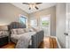 A primary bedroom with hardwood floors and neutral tones, with a glimpse into the closet at 1532 Meade St, Denver, CO 80204
