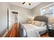Well-lit bedroom with hardwood floors, neutral walls and view of a hallway and closet at 1532 Meade St, Denver, CO 80204