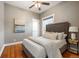 Cozy bedroom with hardwood floors, a ceiling fan, and ample natural light at 1532 Meade St, Denver, CO 80204