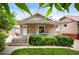 Charming brick home featuring a cozy front porch, landscaped yard, and a delightful light blue front door at 1532 Meade St, Denver, CO 80204