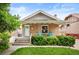 Charming brick home with a cozy front porch, manicured landscaping, and inviting curb appeal at 1532 Meade St, Denver, CO 80204