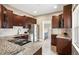 Modern kitchen featuring granite countertops, stainless steel appliances, and dark wood cabinets at 1532 Meade St, Denver, CO 80204